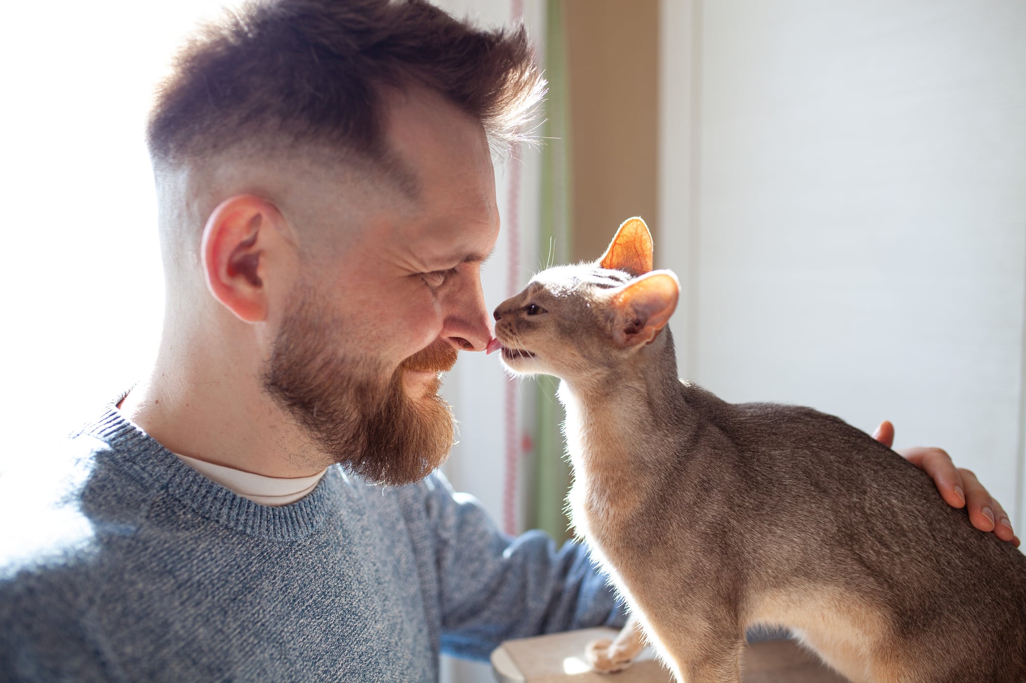 A man sharing an affectionate moment with his cat